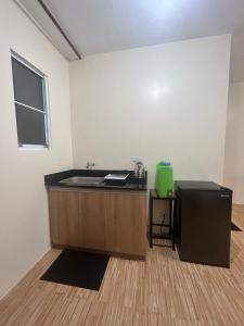 an office with a desk and a sink in a room at BRIA FLATS LAS PINAS in Manila