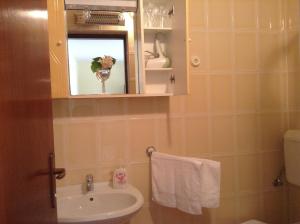 a bathroom with a sink and a mirror at Guesthouse Aotearoa Premantura in Premantura