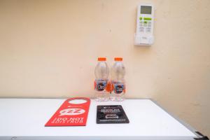 two bottles of soda sitting on top of a table at RedDoorz near Plaza Ambarrukmo Yogyakarta in Seturan +15 photos