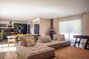 a living room with two couches and a table at Jolie villa au calme avec piscine in Méounes-lès-Montrieux