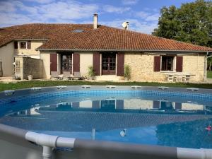 a swimming pool in front of a house at Gîte vallée magique Panissaud in Le Grand-Madieu