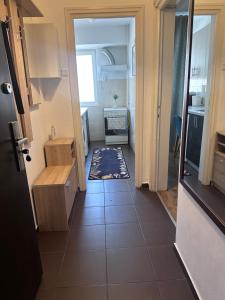 a hallway leading to a small kitchen with a tile floor at Ultracentral - Apartament pe Calea Victoriei in Bucharest +12 photos