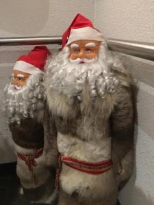 two santa claus figurines are hanging on a wall at Aurora Center 3 in Rovaniemi