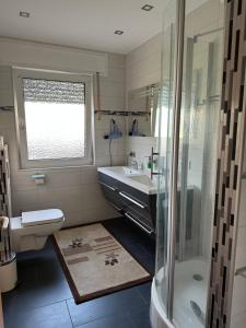 a bathroom with a sink toilet and a shower at Diamanthaus deluxe 7 Koblenz in Koblenz