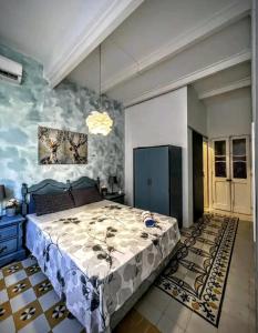 a bedroom with a large bed and a blue wall at Townhouse 88 cloudy room in Sliema