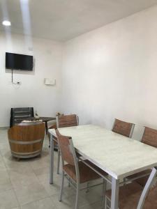 a room with a table and chairs and a wooden barrel at cabaña merlot in Cafayate