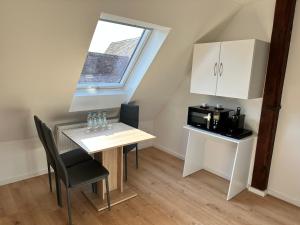 a small kitchen with a table and a microwave at Apartment Obermichelbach in Obermichelbach