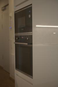 a kitchen with a microwave and a stove at Appartement New Town in Dresden
