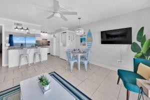 a living room and kitchen with a table and chairs at Oceanfront Condo #507 at Summit Beach Resort in Panama City Beach