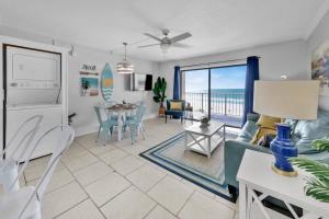 a living room and dining room with a view of the ocean at Oceanfront Condo #507 at Summit Beach Resort in Panama City Beach