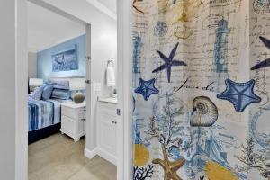 a bedroom with a shower curtain with stars on it at Oceanfront Condo #507 at Summit Beach Resort in Panama City Beach +47 photos