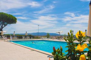a swimming pool with chairs and umbrellas at Argentario Osa Resort in Talamone +94 photos