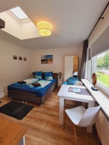 a bedroom with a bed and a table in a room at Apartmenthaus am Park in Wilhelmshaven