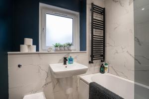 a bathroom with a sink and a toilet and a tub at Modern 2BED Apartment-Free Parking in Edinburgh