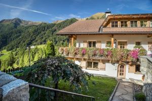 a house in the mountains with flowers at Adults Only Wasserfall Hegedex in Fundres