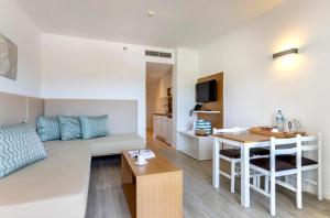 a living room with a couch and a table at Houm Plaza Son Rigo in Playa de Palma