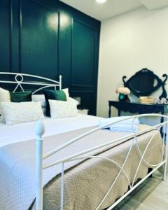 een slaapkamer met een wit bed met een zwart hoofdeinde bij Le Case Col Sole da Silvia INTERNO 1 in Cisterna di Latina