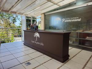 a bar in a restaurant with a sign that reads just reason pirlanulum at Hotel Fazenda Pommernland in Pomerode