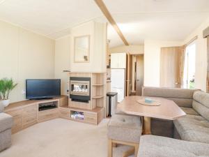a living room with a couch and a tv at E10 Eagle Meadows in Paignton
