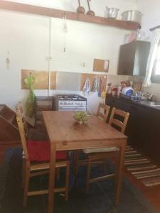 a kitchen with a wooden table and chairs in a kitchen at The Mouflon House Pedoulas in Nicosia