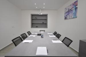 a conference room with a long table and chairs at Zett hotel in Jounieh