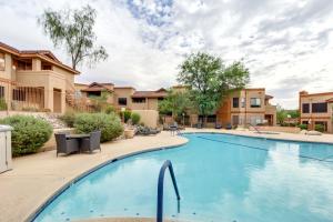 a large swimming pool at a apartment complex with condos at Tucson Escape with Outdoor Community Pool and Hot Tub! in Tucson