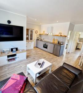 a large living room with a couch and a kitchen at Ferienwohnung Bad Doberan in Bad Doberan