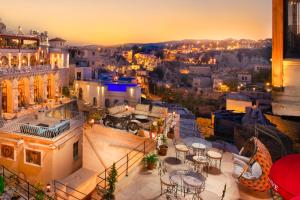 a view of a city at night with tables and chairs at Carna Cave Hotel Cappadocia in Ortahisar
