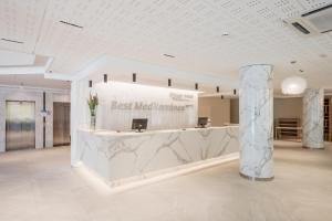 a lobby with a best matchinator sign on a marble counter at Hotel Best Mediterraneo in Salou +22 photos