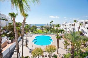 an aerial view of a resort with a swimming pool and palm trees at Best Club Vacaciones Pueblo Indalo in Mojácar