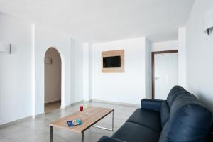 a living room with a couch and a coffee table at Best Club Vacaciones Pueblo Indalo in Mojácar