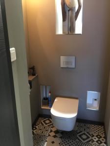 a bathroom with a white toilet and a mirror at Ajaccio . chambre avec vue in Ajaccio