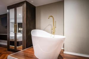 a bathroom with a bath tub with a gold faucet at 34 Coney Street in York