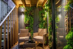a patio with two chairs and a green wall at 34 Coney Street in York