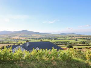 a house in the countryside with mountains in the background at Valley View in Enniscorthy