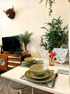 a table with two bowls and plates on it at The Ferns - Shared Garden Apartment With Parking in Darvel