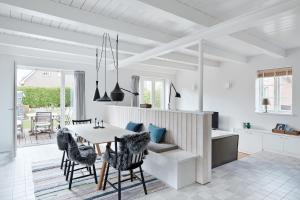 a kitchen and dining room with a table and chairs at Hygge Hus in Oevenum