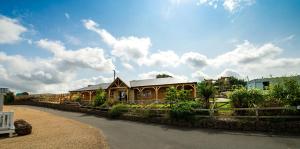 a house with a fence next to a road at Beamish Holiday Park in Stanley