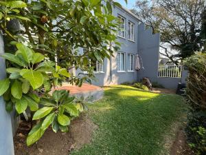 a white house with a yard with green grass at Royal Retreat in Roodepoort