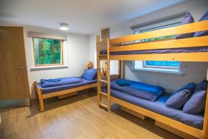 a room with two bunk beds and a window at Glen Nevis Youth Hostel in Fort William