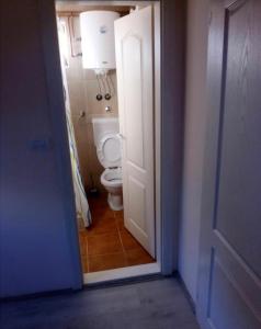 an open door to a bathroom with a toilet at Sobe Spaske in Čačak