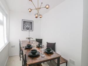 a dining room with a wooden table and chairs at 38 Clyffe Pypard in Swindon