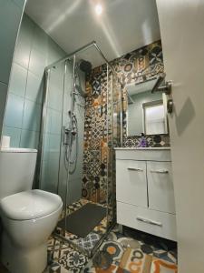 a bathroom with a toilet and a glass shower at En-Suite Bedroom and Garage in Porto City Center in Porto