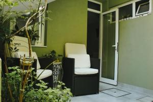 a room with two chairs in a room with plants at En-Suite Bedroom and Garage in Porto City Center in Porto