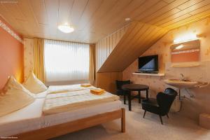 a hotel room with a bed and a sink at Privat-Pension Doemens in Aachen