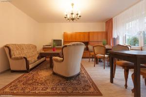 a living room with chairs and a dining room at Privat-Pension-Doemens in Aachen