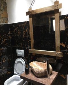 a bathroom with a sink and a toilet at Kulla Relax in Elbasan +49 photos