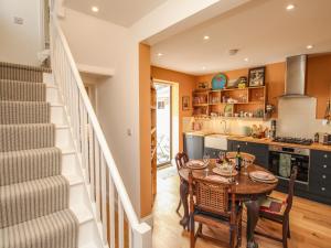 une cuisine et une salle à manger avec une table et des chaises dans l'établissement The Corner House, à Weymouth