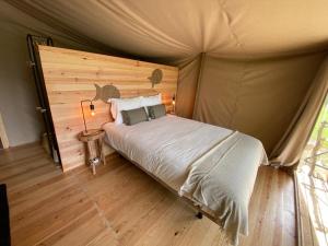 a bedroom with a bed in a tent at Parque dos Monges in Alcobaça