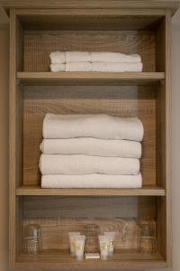 a shelf with towels and other towels in a bathroom at Tralee Townhouse in Tralee